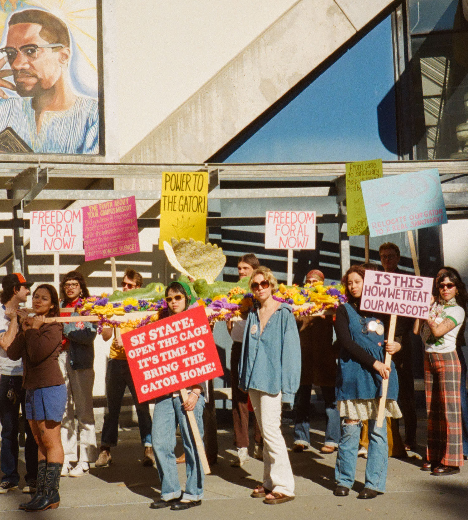Students outside the Cesar Chavez Student Center with pickets for March of the Gator.