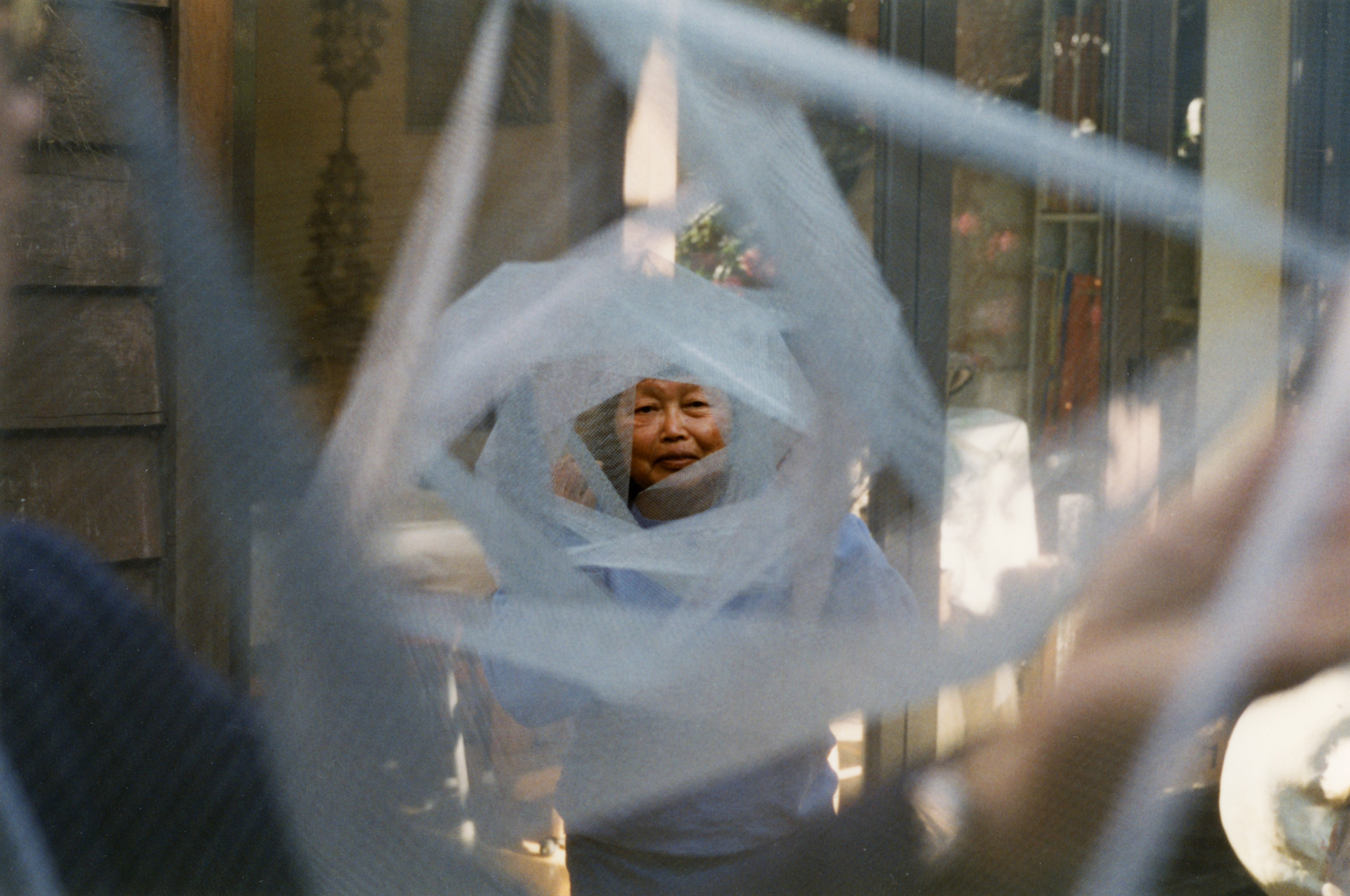 Ruth Asawa holding a project made in collaboration with SFSU students