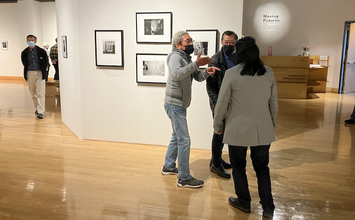 Moving Pictures exhibit with three people
