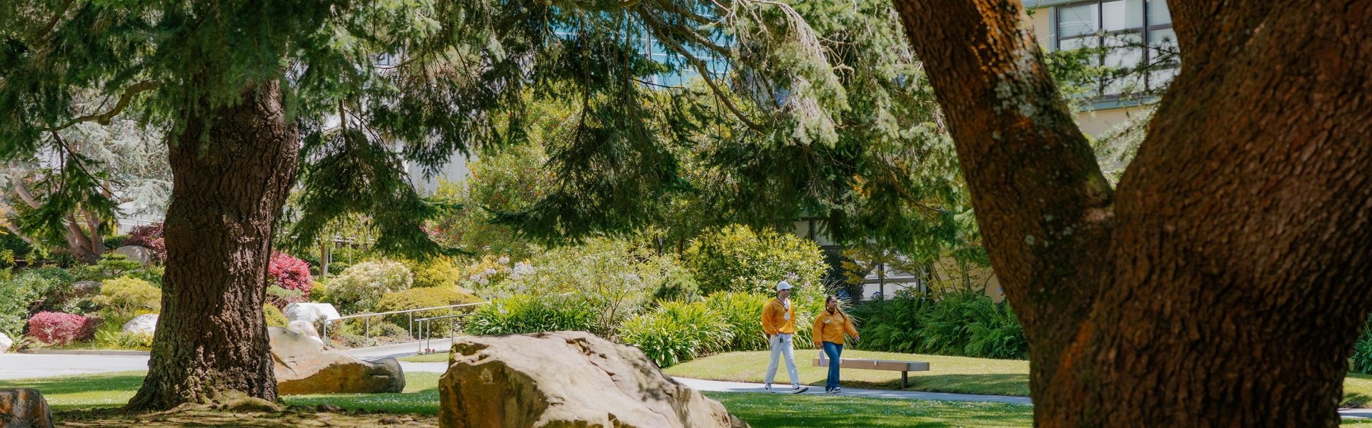 Two students walking through the Garden of Remembrance at SFSU